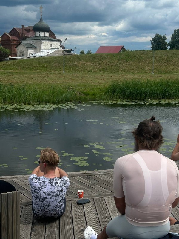 Две участницы отдыхают у воды во время остановки на маршруте