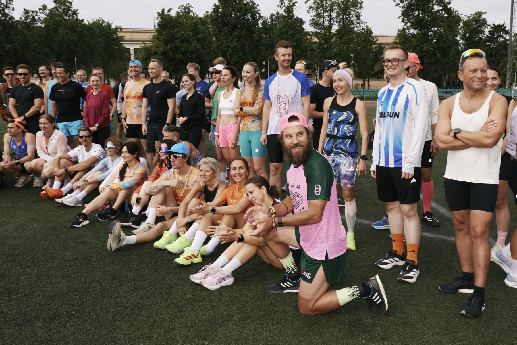 Viktor Doronin and a large training group pose together on a track