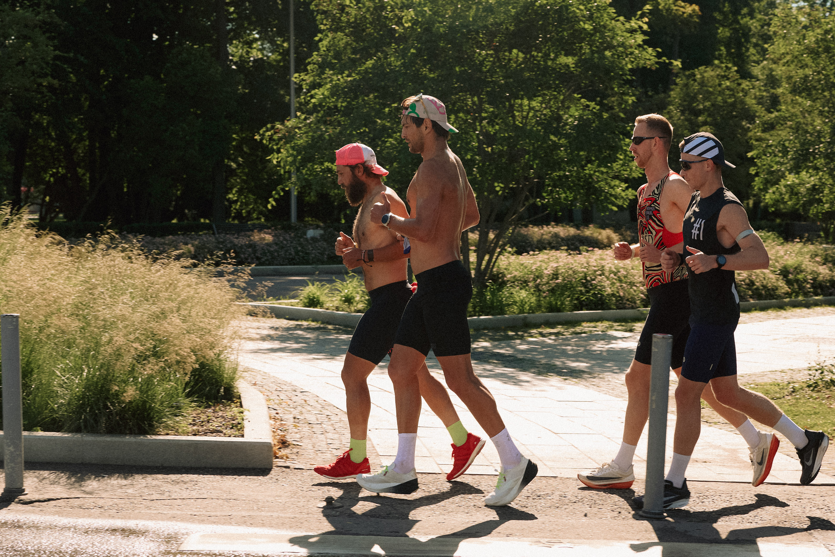 Viktor Doronin runs alongside other athletes on a sunlit path