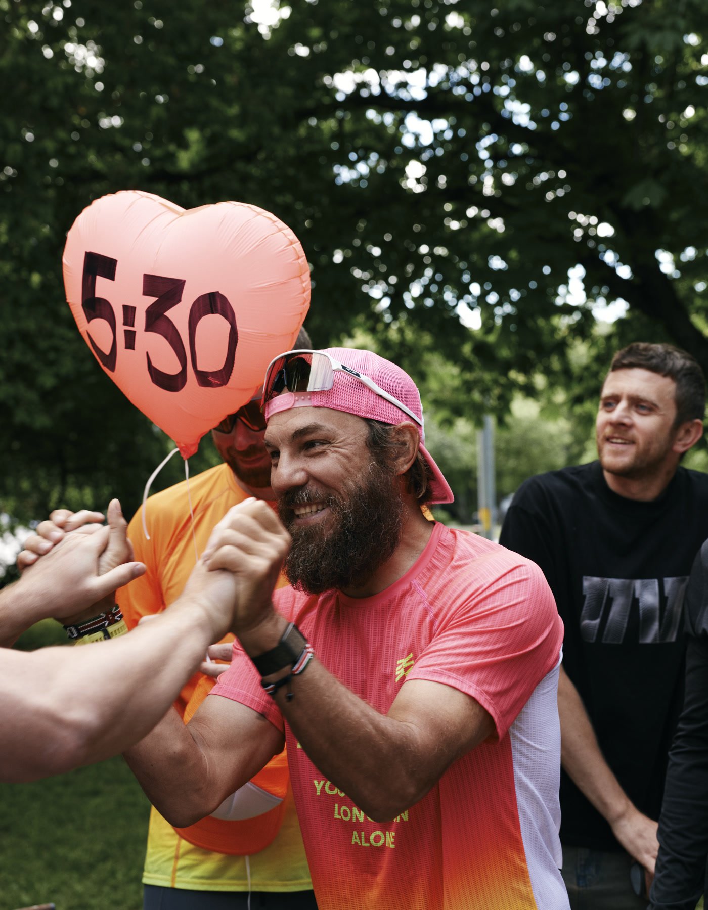 A smiling Viktor Doronin clasps hands with people after training
